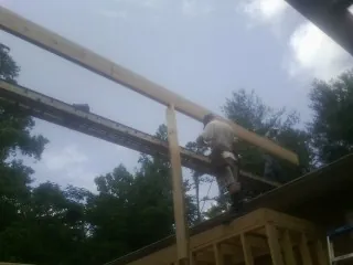 Carpenter setting a ridge beam over a new addition frame — Ice Dam Removal by Roofing Brothers in Fort Calhoun